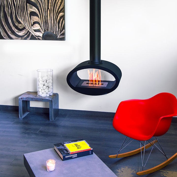 bioethanol-haengekamin-deckenmontage-ellipse-2side-ethanol-kamin-decke-schwarz-mit-flammen-modernes-wohnzimmer-roter-schaukelstuhl-vor-weisser-wand-anthrazit-boden
